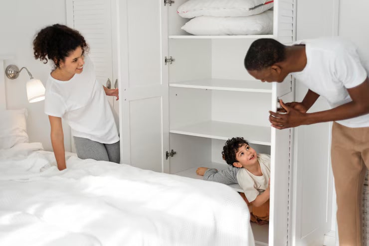 happy-child-playing-hide-seek-with-his-parents-in his new room