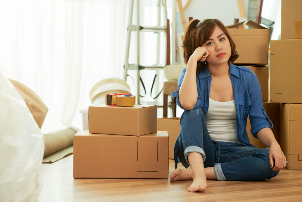 young woman moving out of house