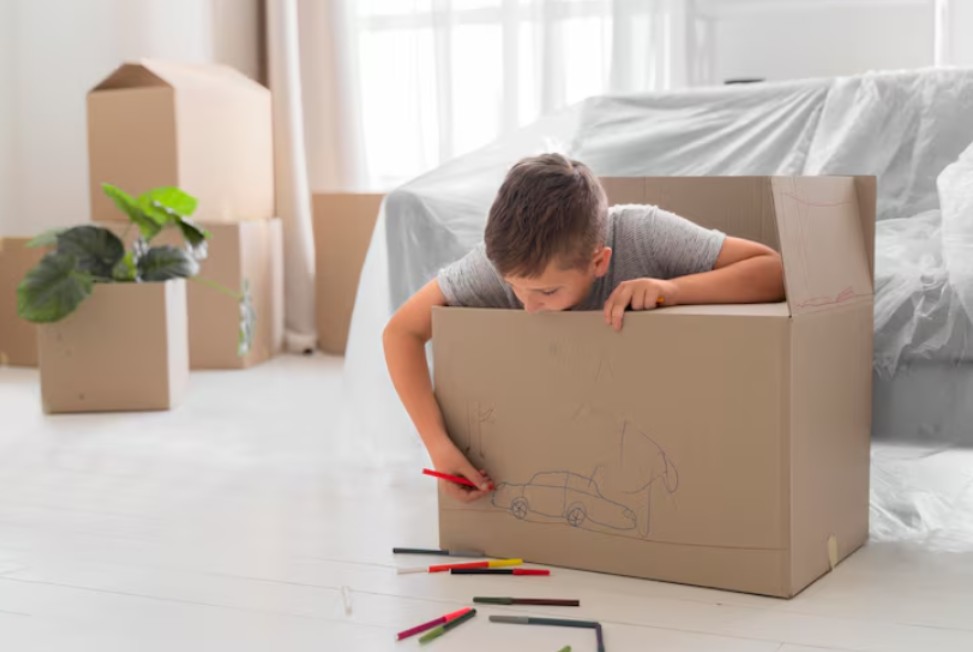 board child drawing on moving box