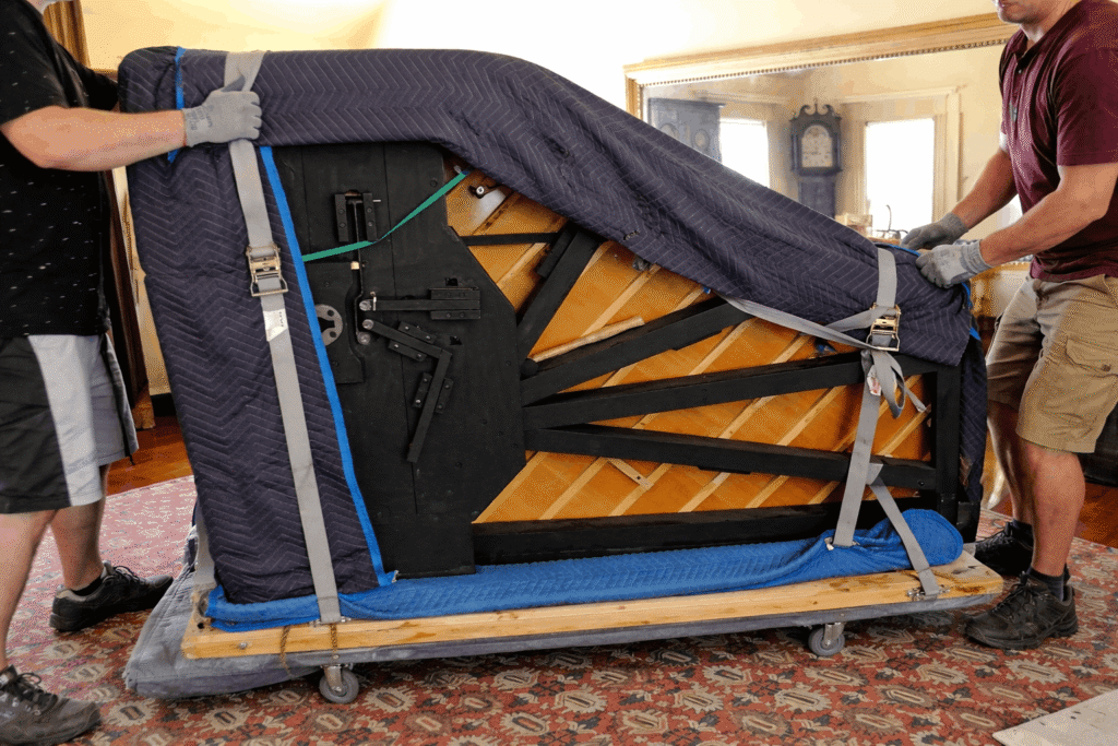 Grand piano on a skid board for transport